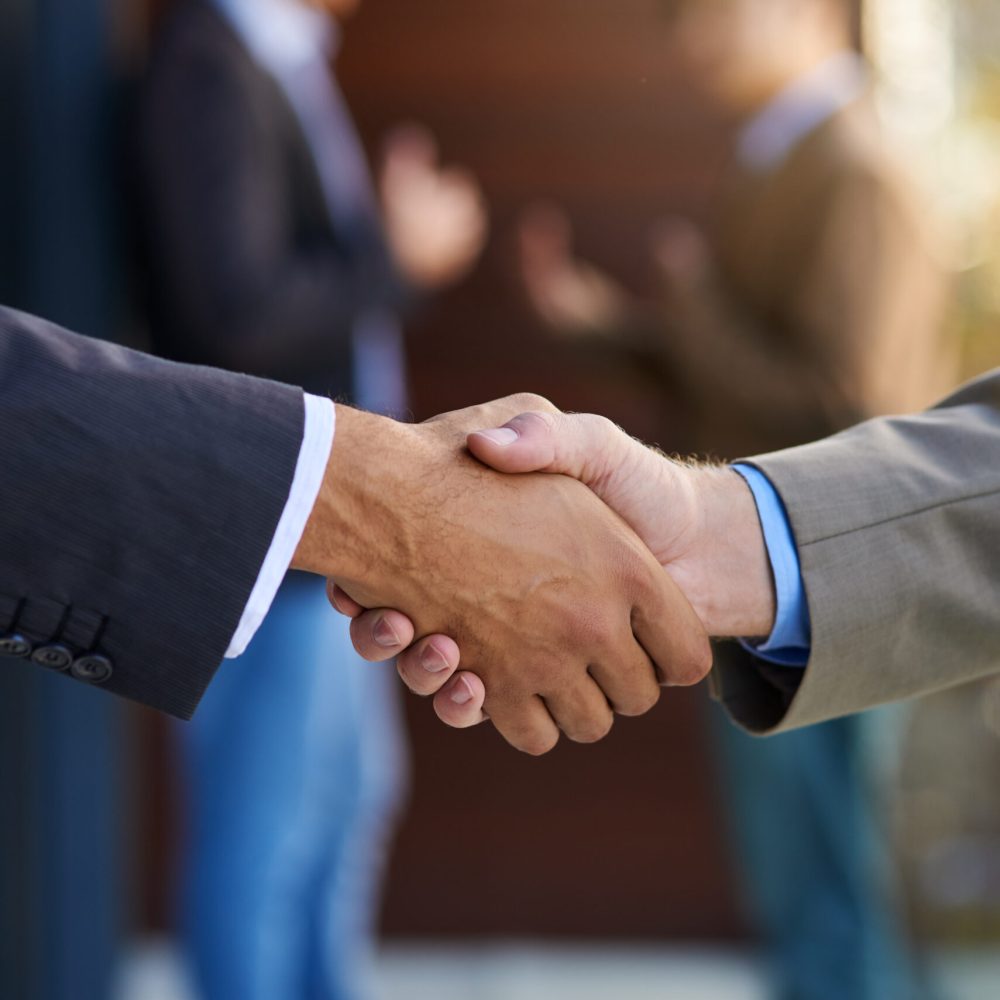 Business agreements. Shot of two businesspeople shaking hands