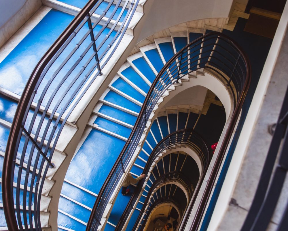 Old blue spiral staircase, spiral stairway inside an old house in Budapest, Hungary, Europe. Project Budapest 100